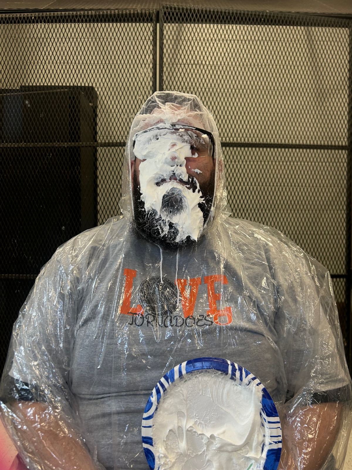 Dr. López taking a pie to the face at a student fundraiser