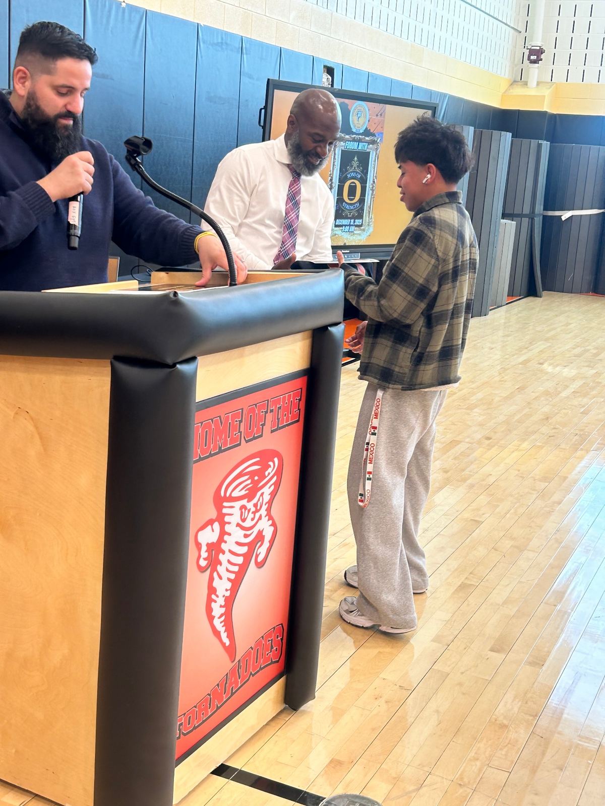 Speaking with a student at a school assembly